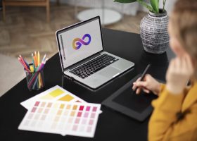 female-logo-designer-working-her-tablet-connected-laptop